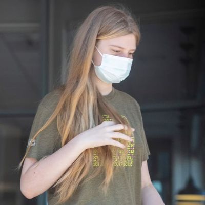 She is seen walking as she is wearing a mask.